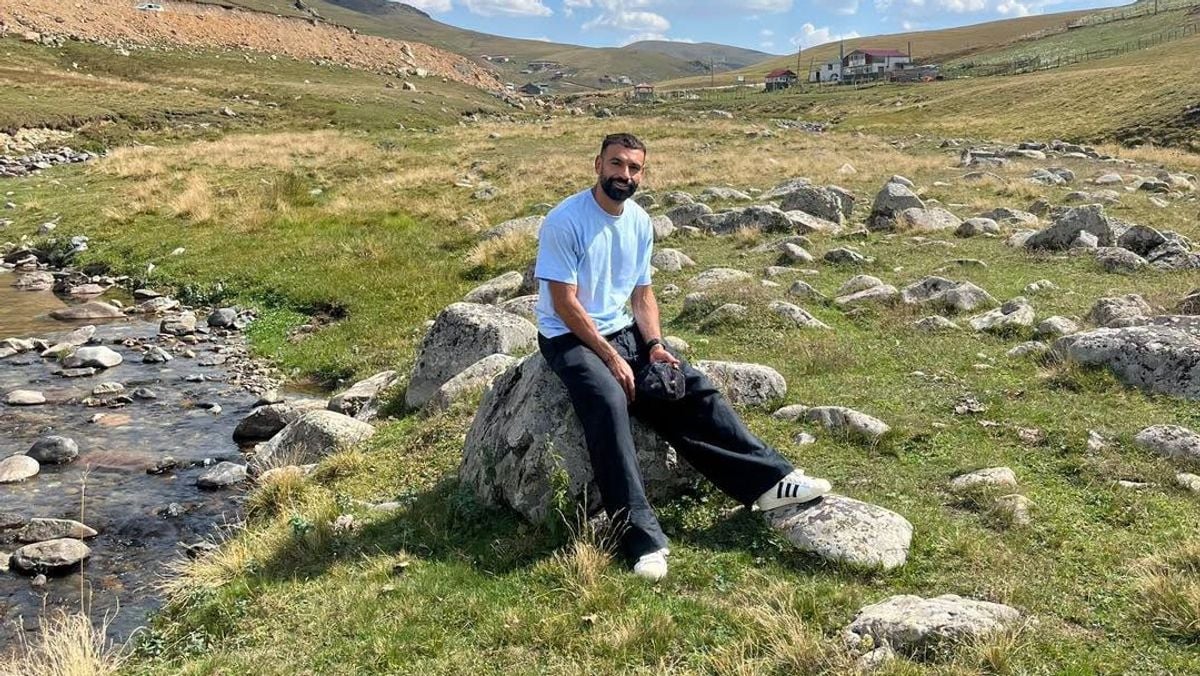 Fans pose on rock in Trabzon after Mohamed Salah's visit